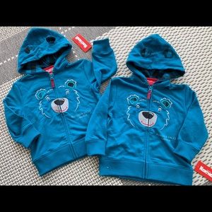 A pair of Niagara Falls hooded zip up sweatshirts